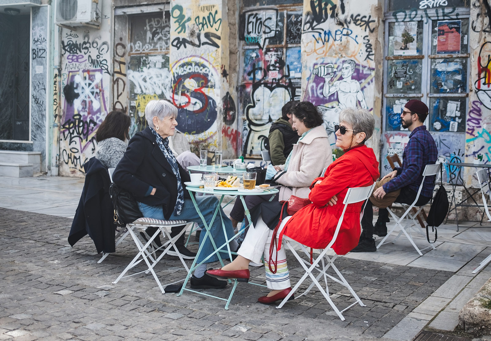 Women sat in street outside café
