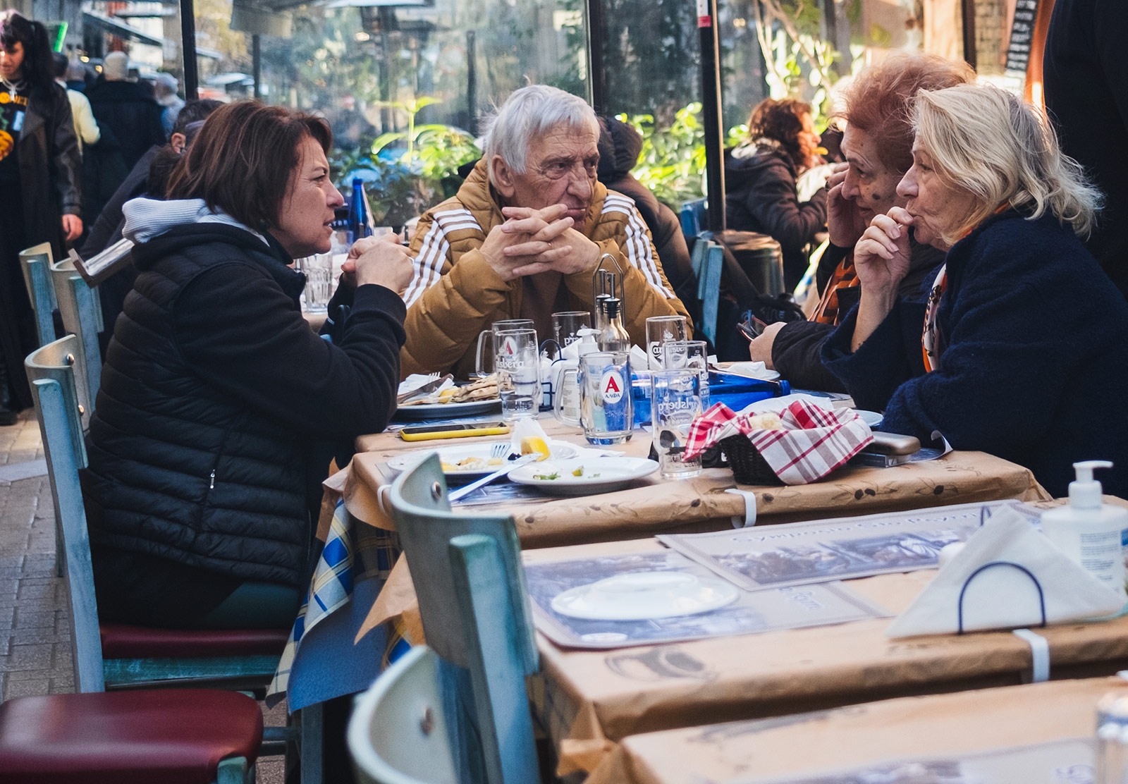 Man and three woman sat at cafe table