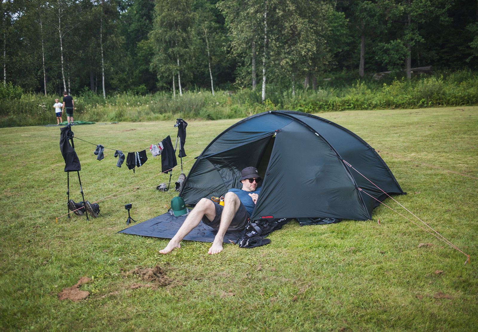 Man relaxing next to a tent