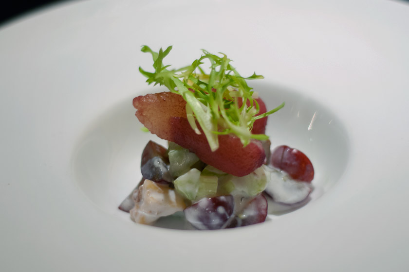 Poached pear on top of grapes and celery