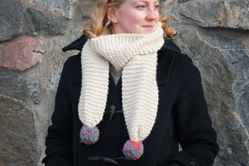 Cream scarf with coloured pompoms