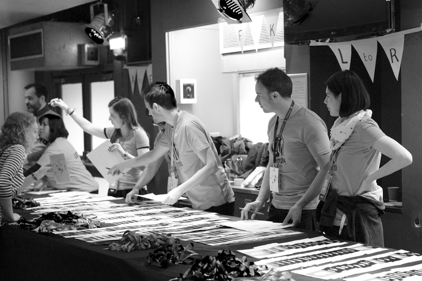 Volunteers with rows of lanyards