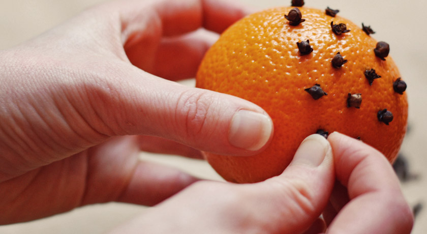 Studding an orange with cloves