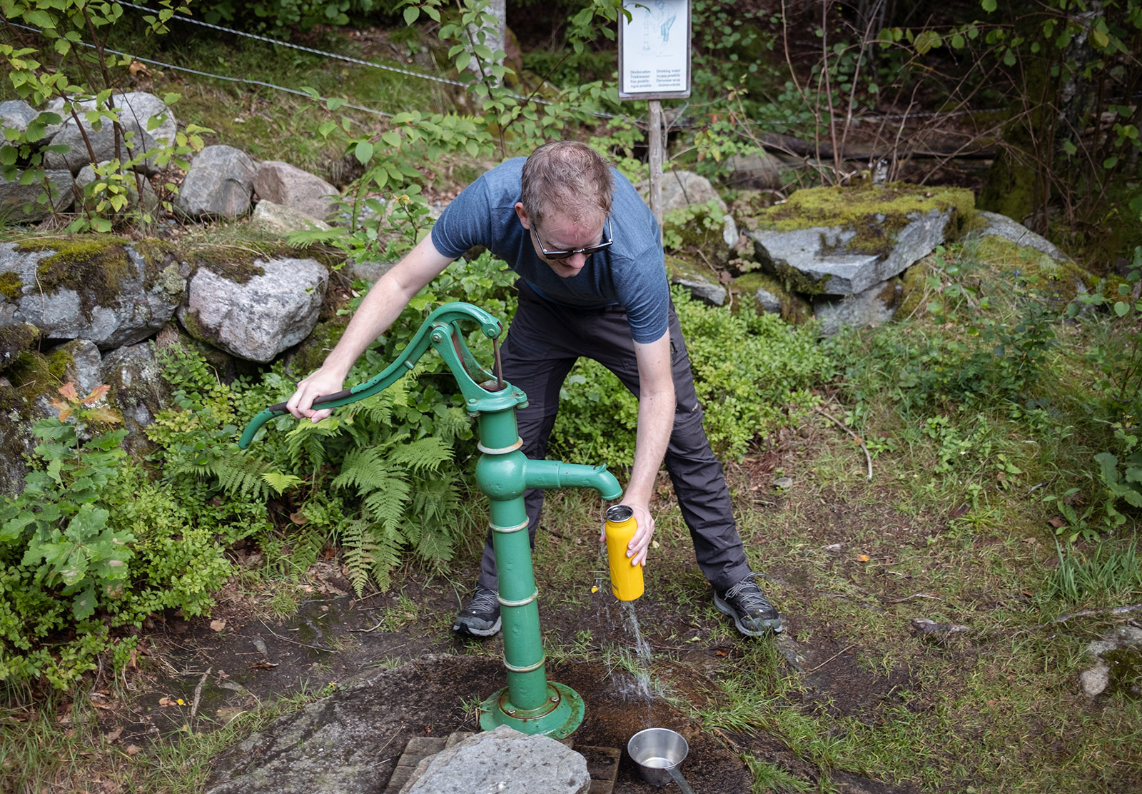 Man pumping water from a well