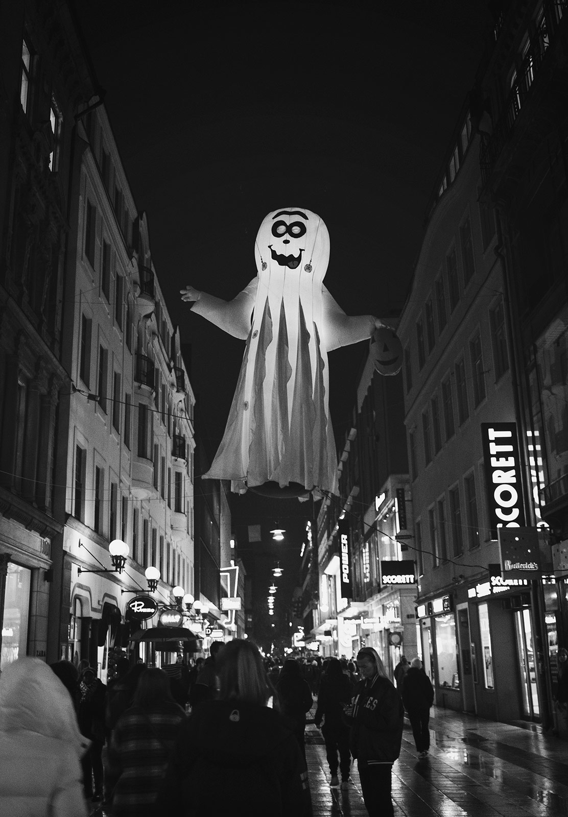 Inflatable ghost hanging over street