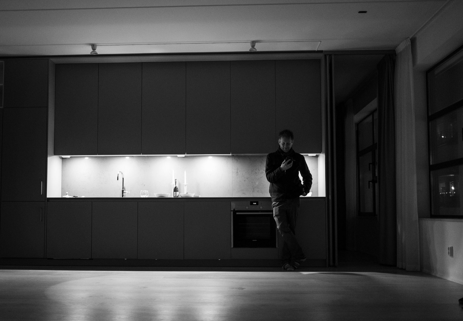 Man stood in empty kitchen