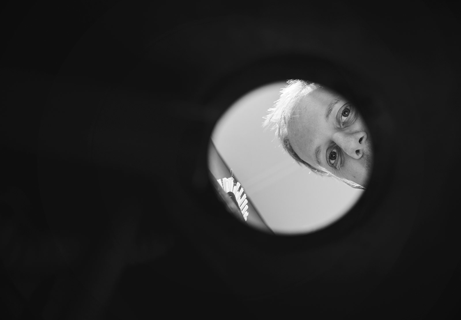 Man peering through sink hole