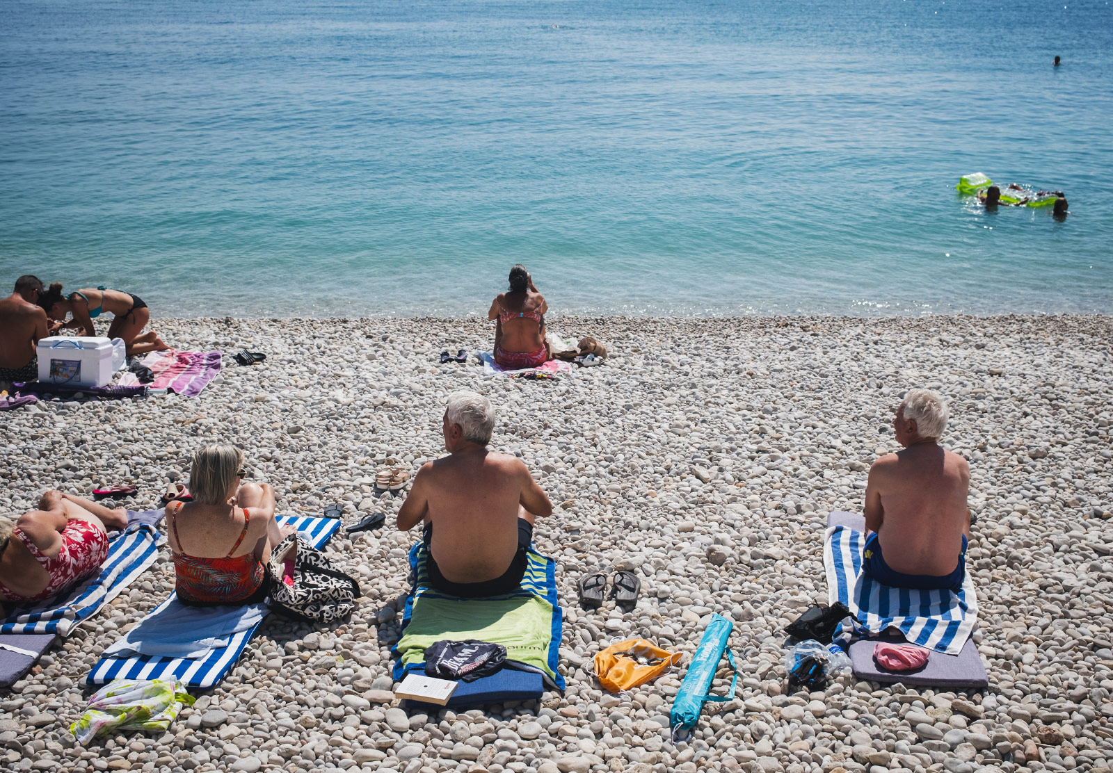 People sunbathing on a pebble beach