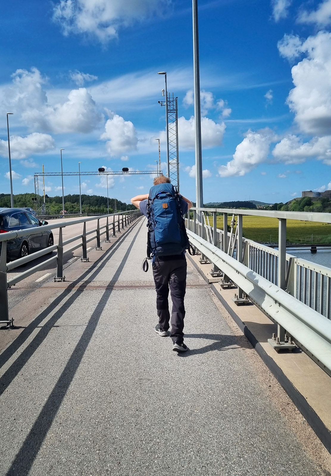 Man walking along bridge path