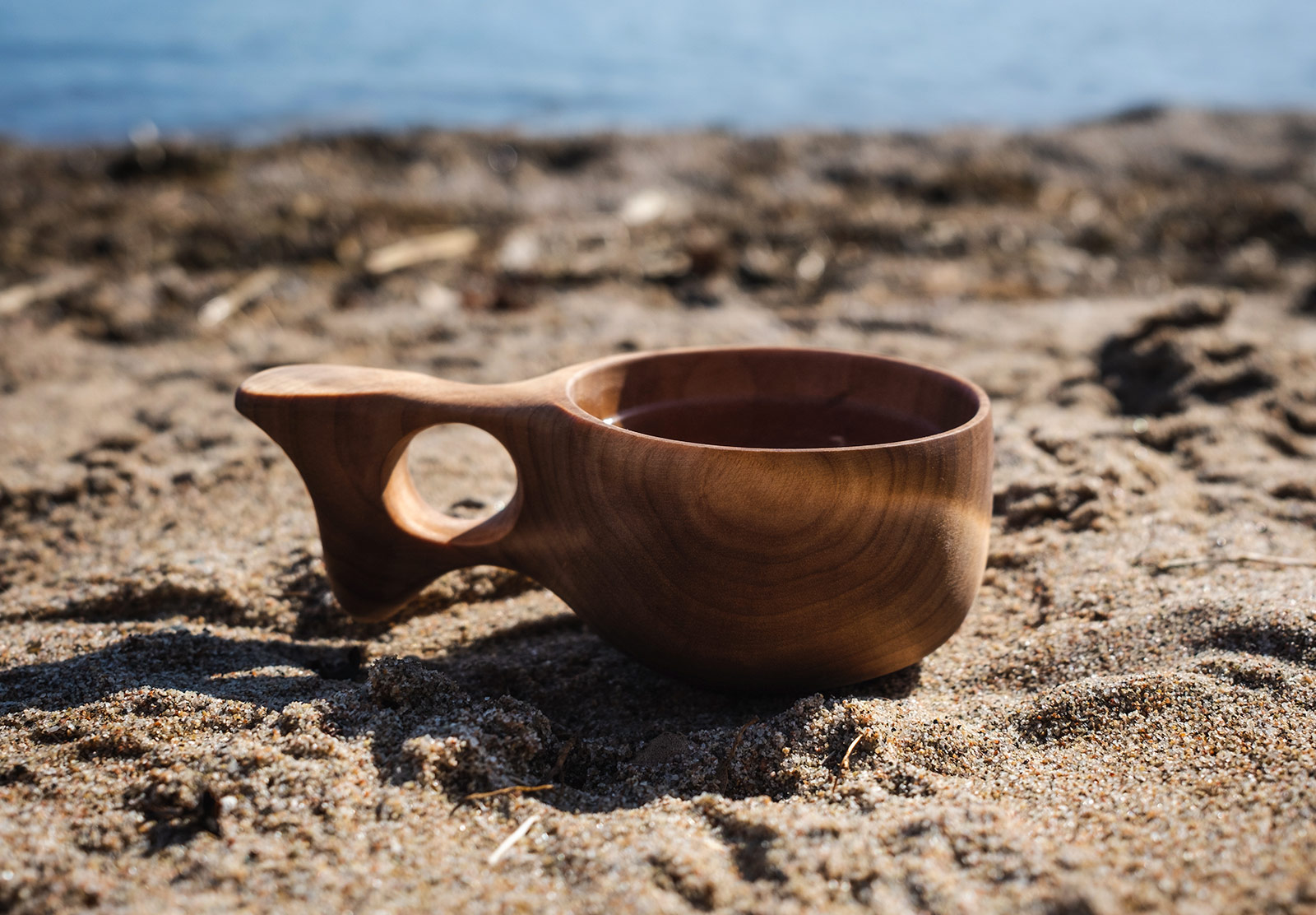 Wooden cup on beach