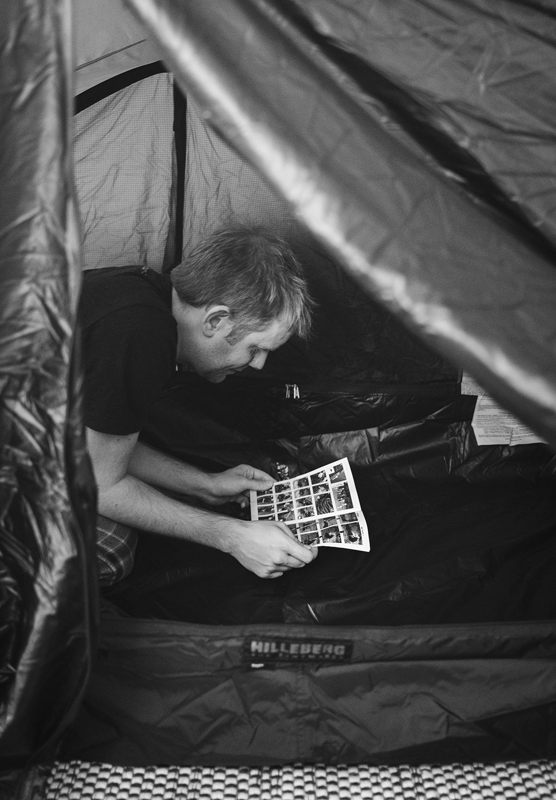 Man reading tent instructions