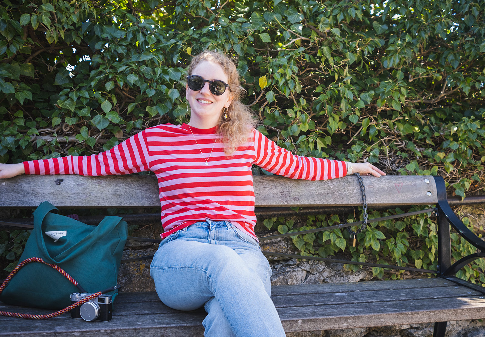 Woman sitting on a bench smiling