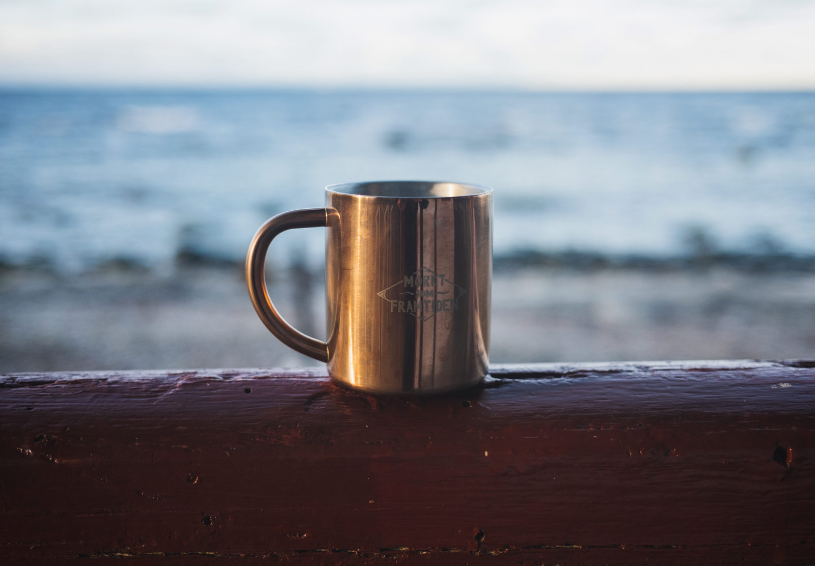 Mug of tea in front of sea