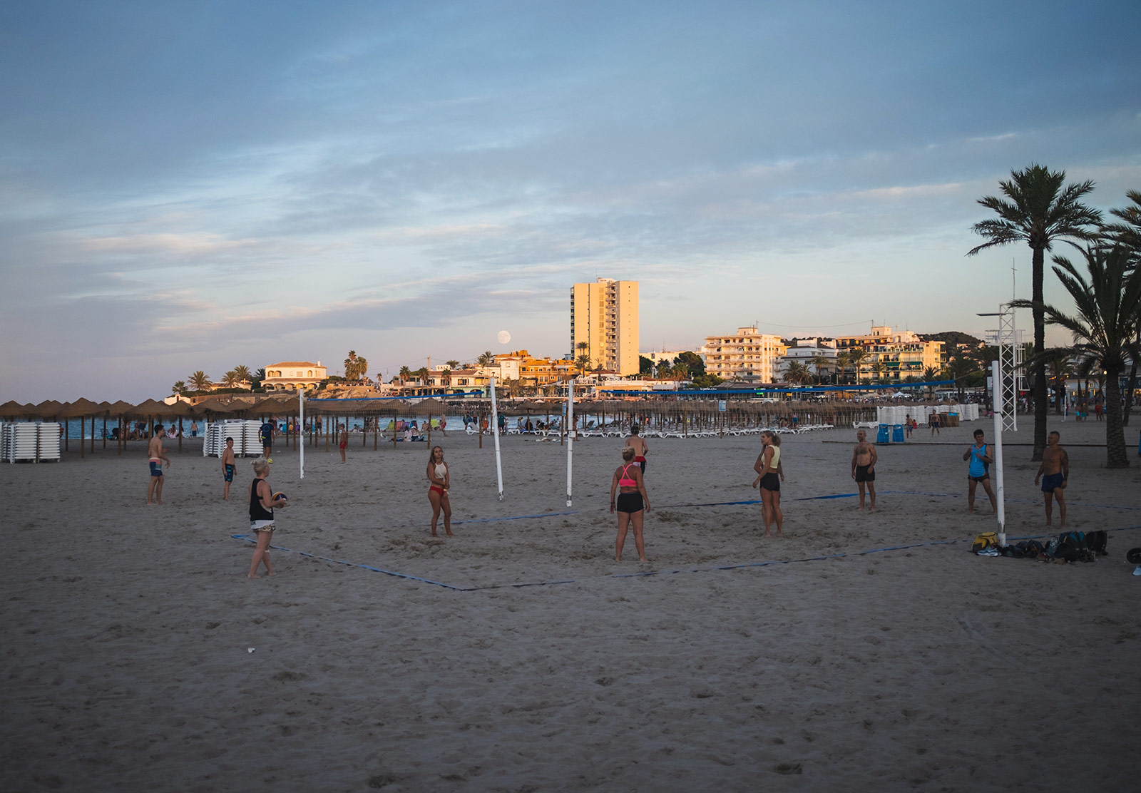 People playing volleyball on the beach
