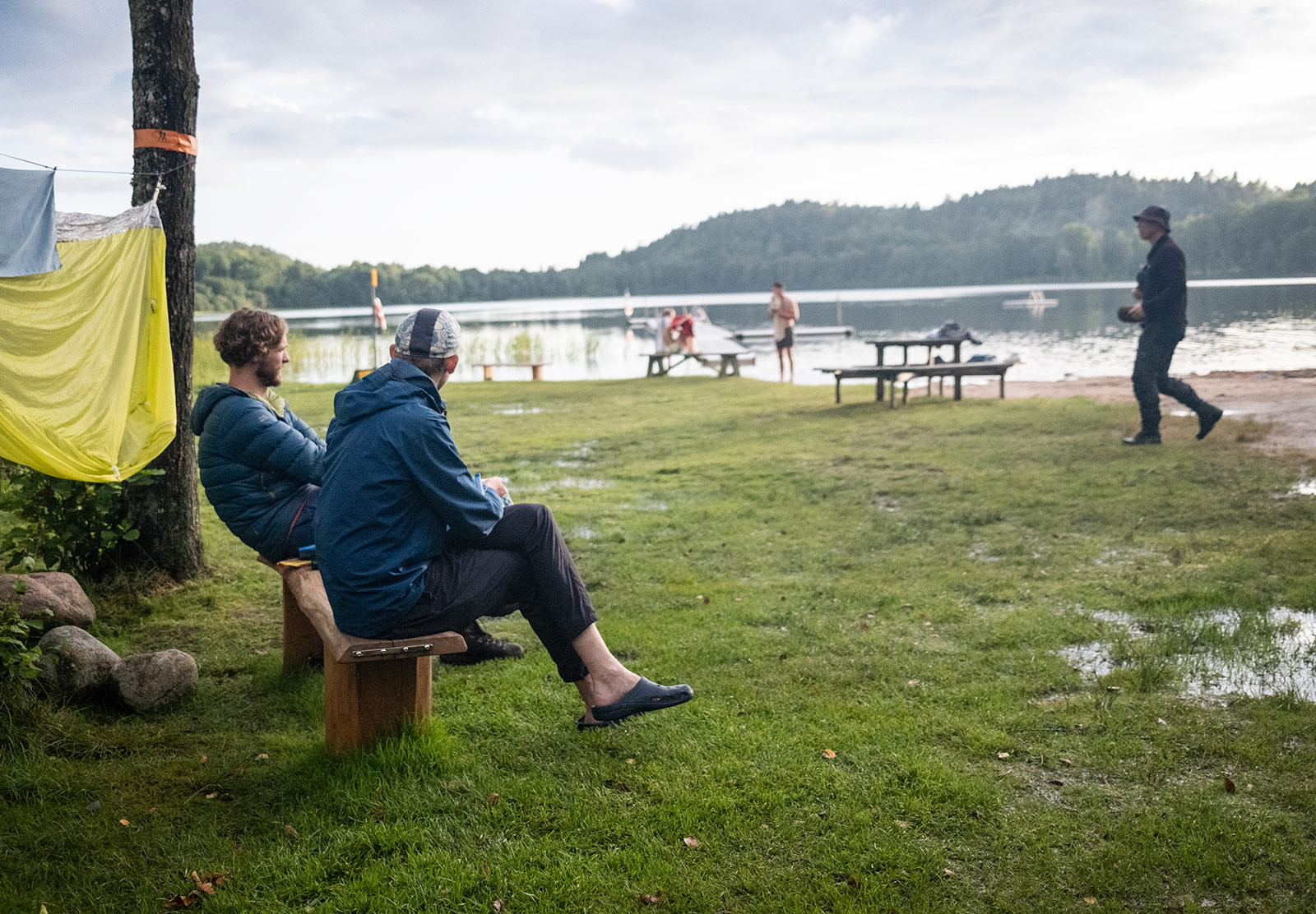 Two people at on a bench next to a lake