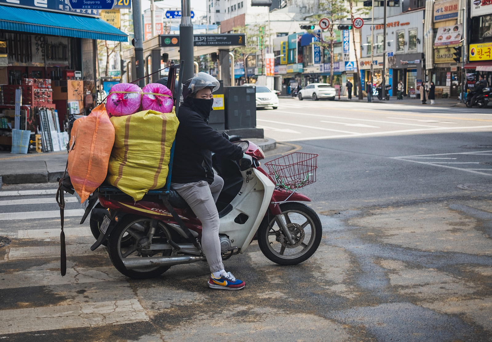 Man with bags stacked on bike