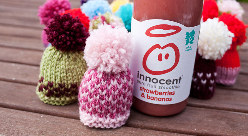 Collection of knitted hats with smoothie bottle