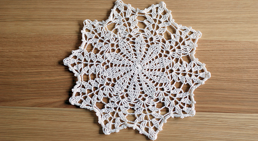 Crochet doily on wooden table