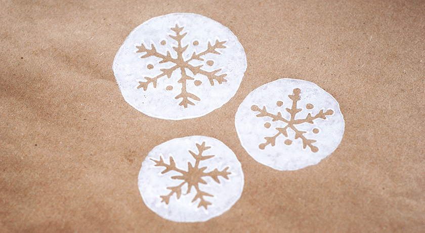 White snowflakes printed on brown paper