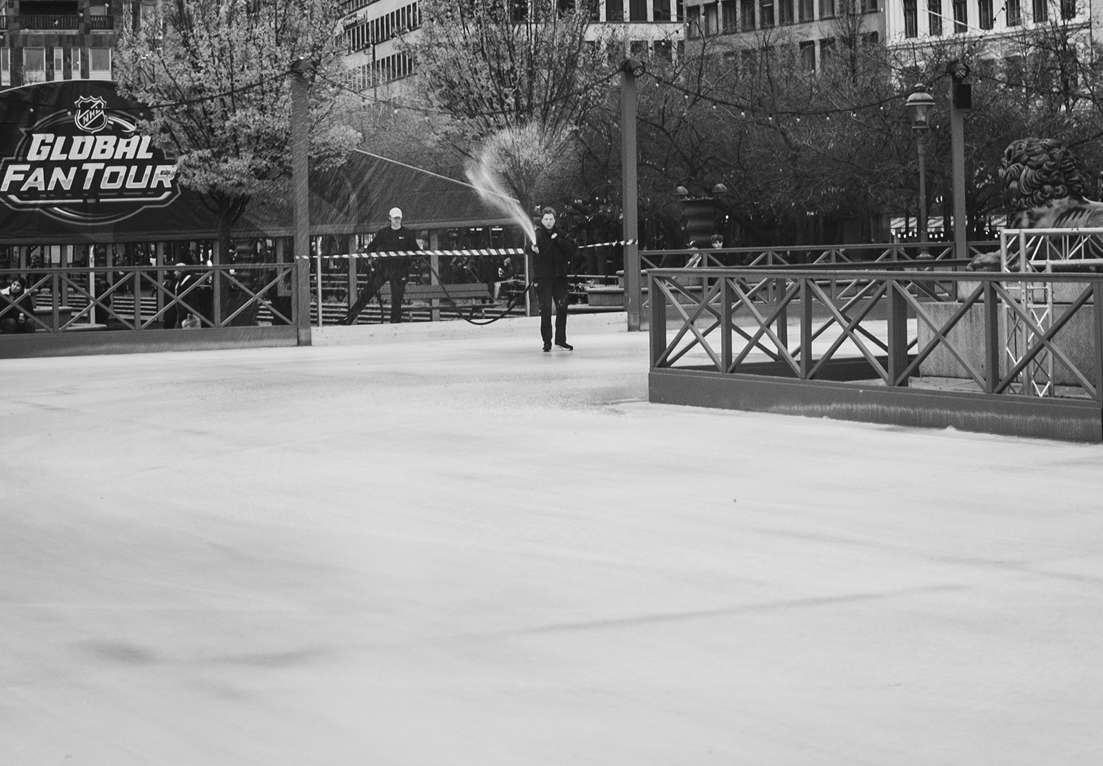 Man spraying ice on skating rink