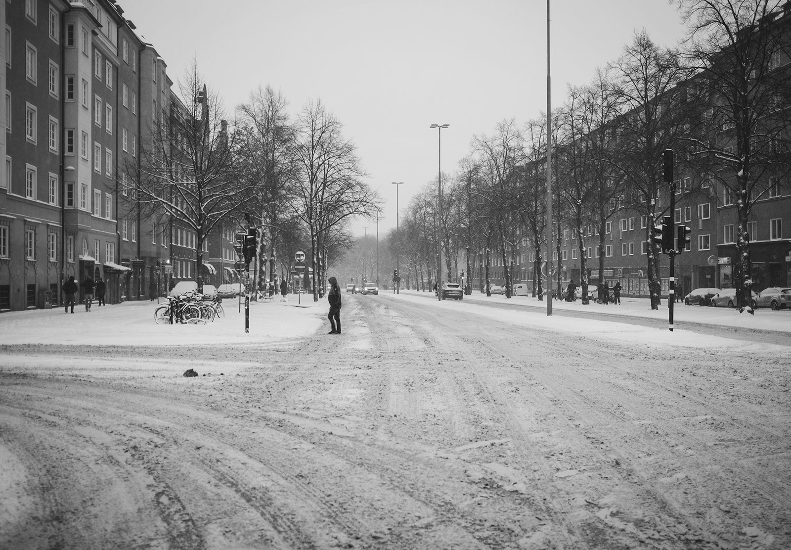 Person walking across snow covered road