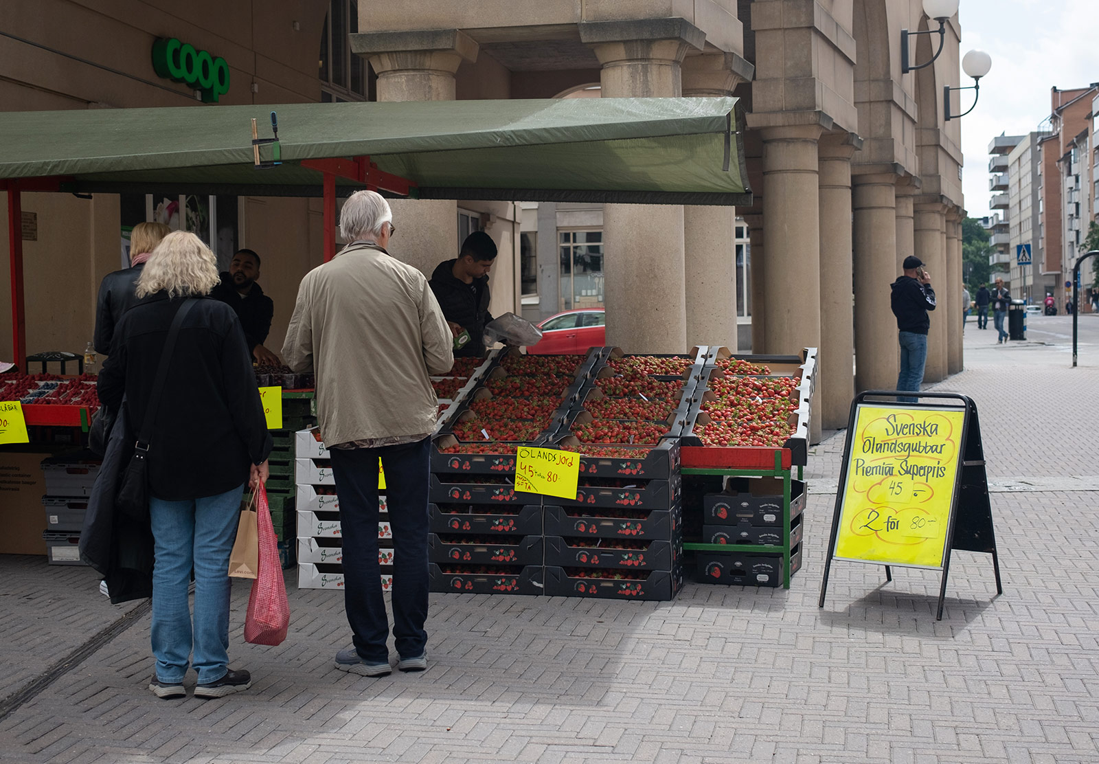 People queueing to buy fruit