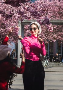 Woman standing in cherry blossom branches