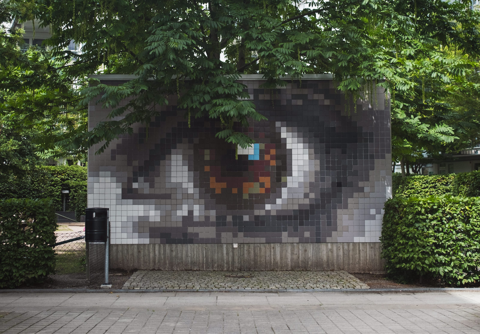 Tiled eye mural on wall