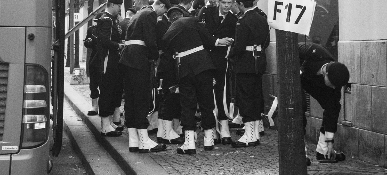 Royal guards gathered next to a bus