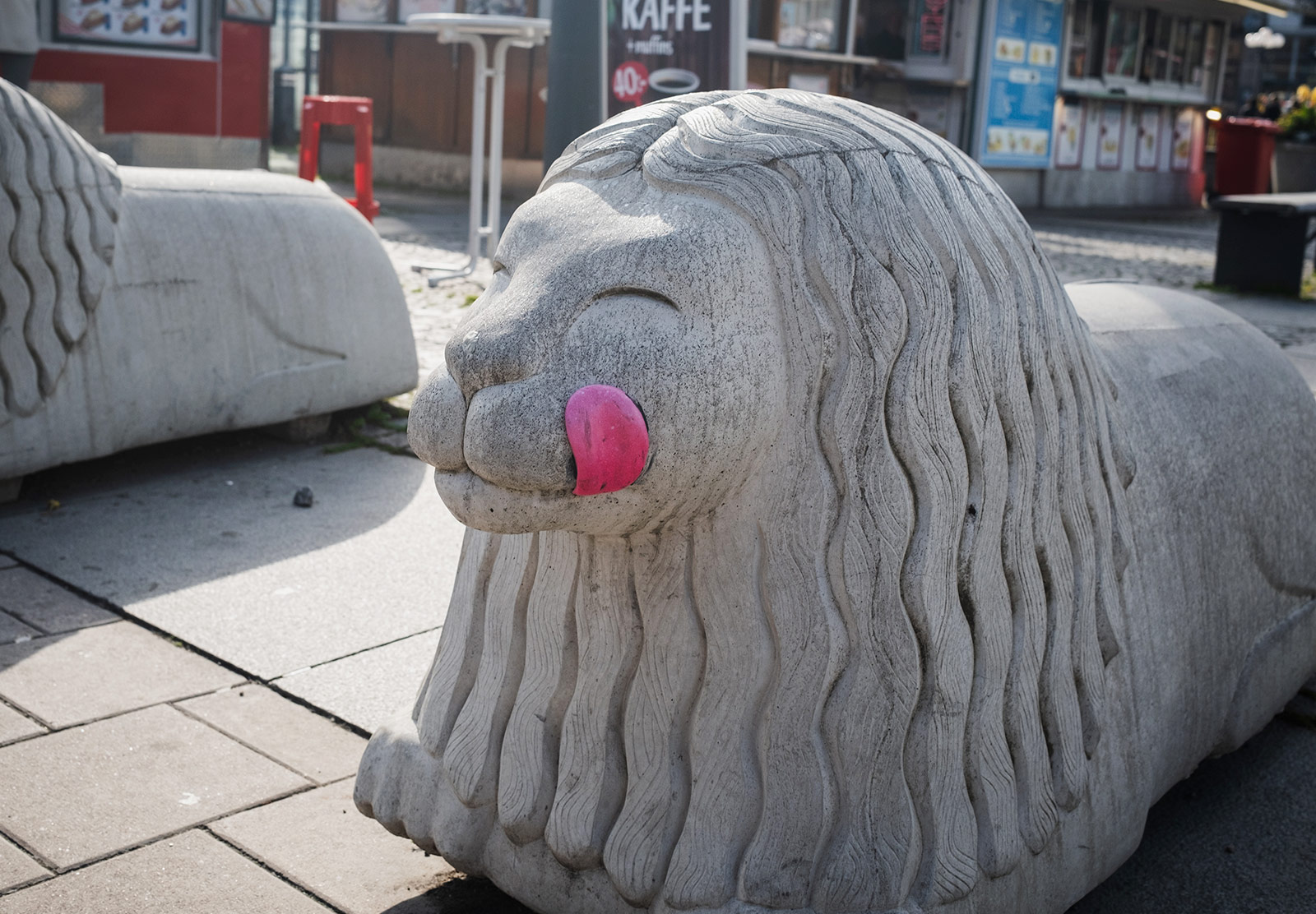 Pink tongue added to concrete lion