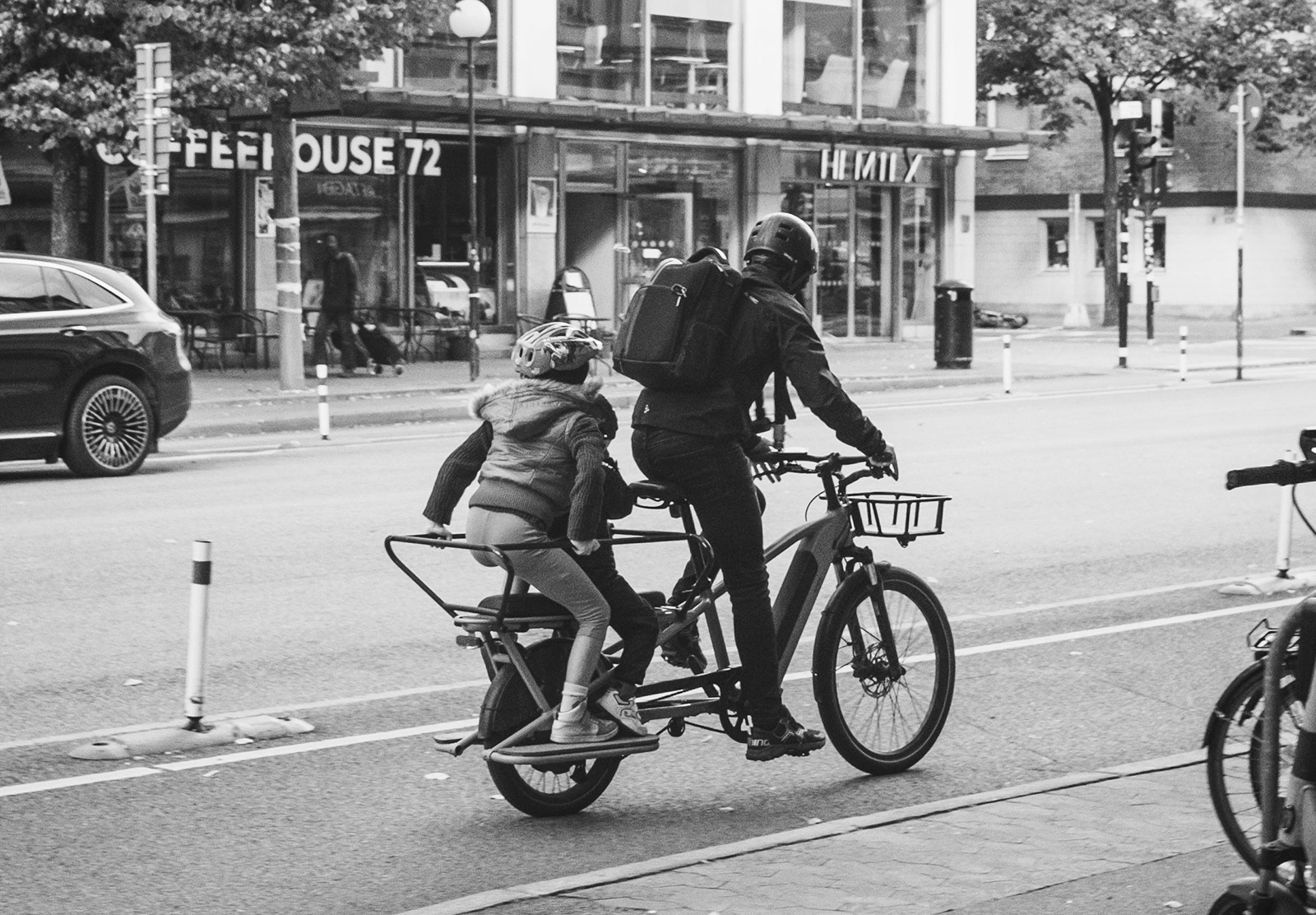 Man cycling with two kids on the bike