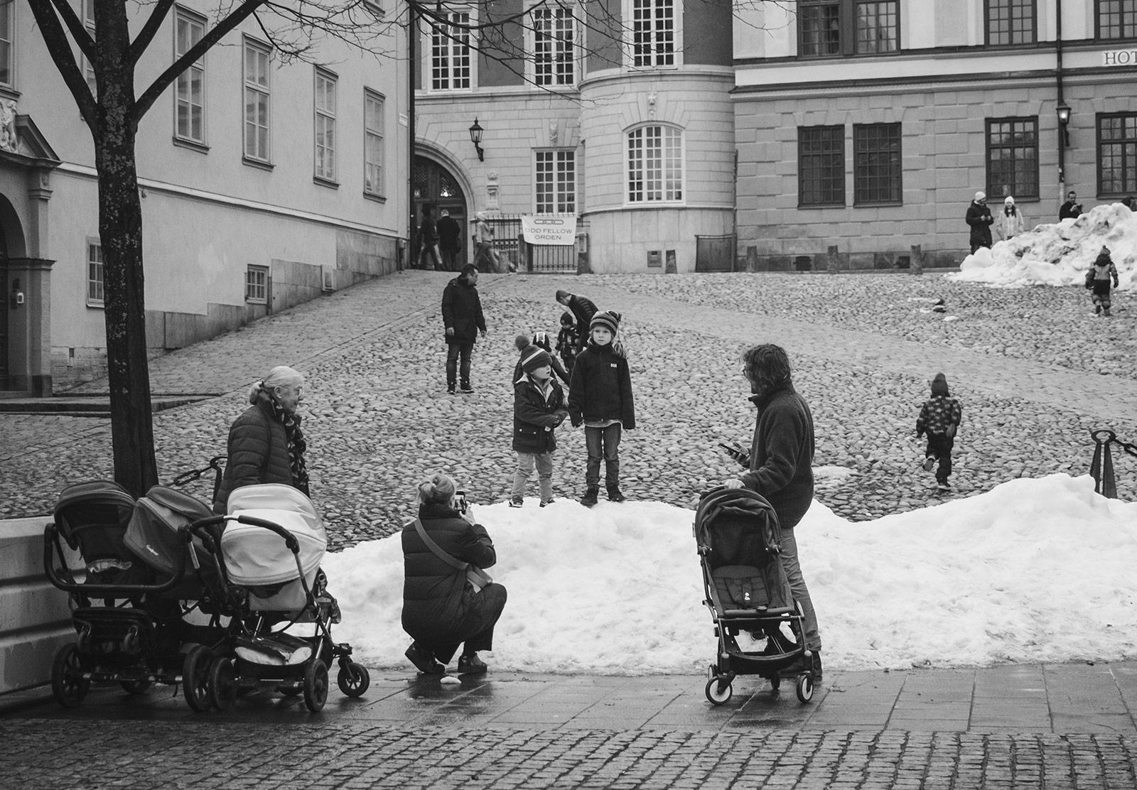 Children standing on snow pile