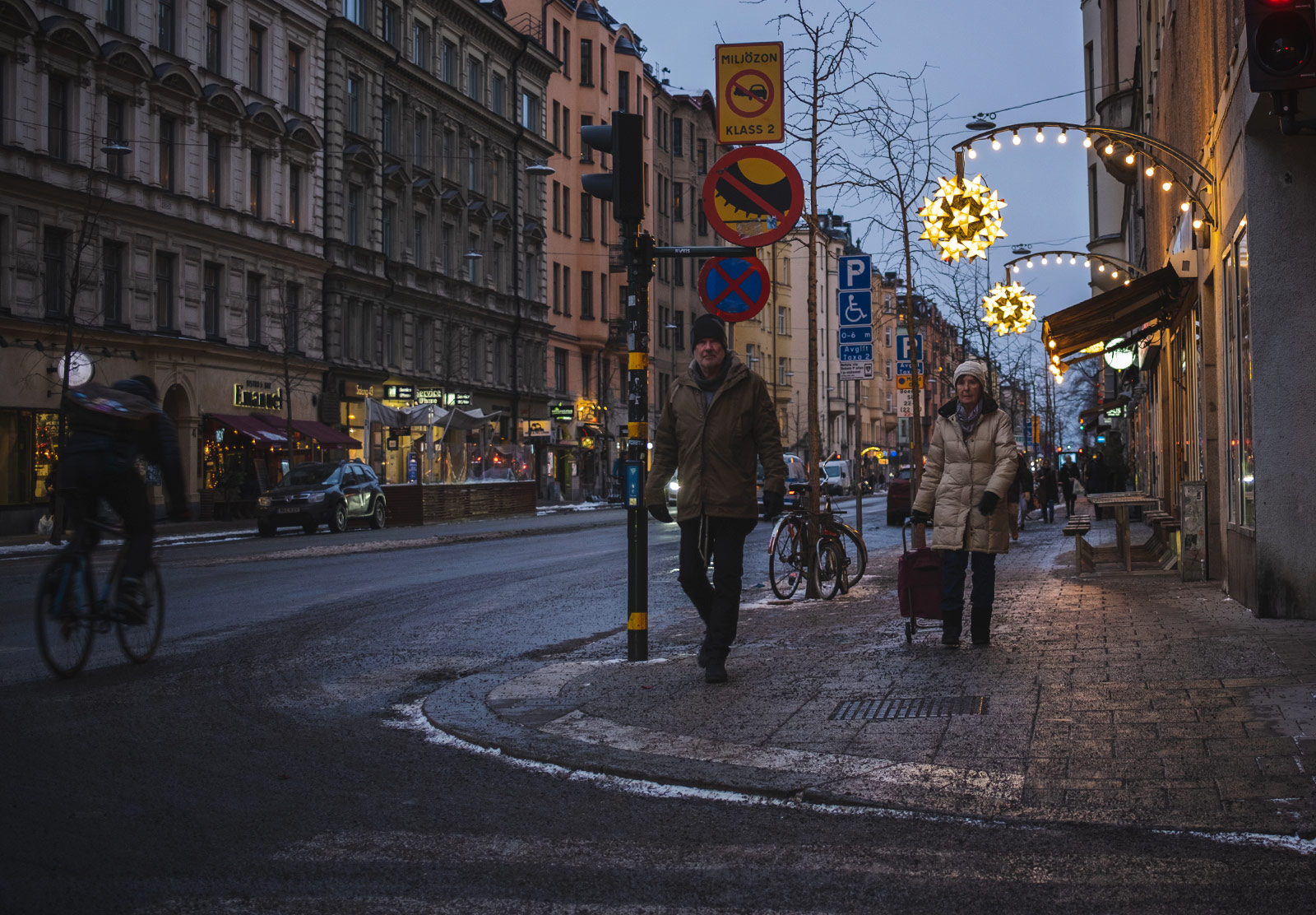 People walking on lit street