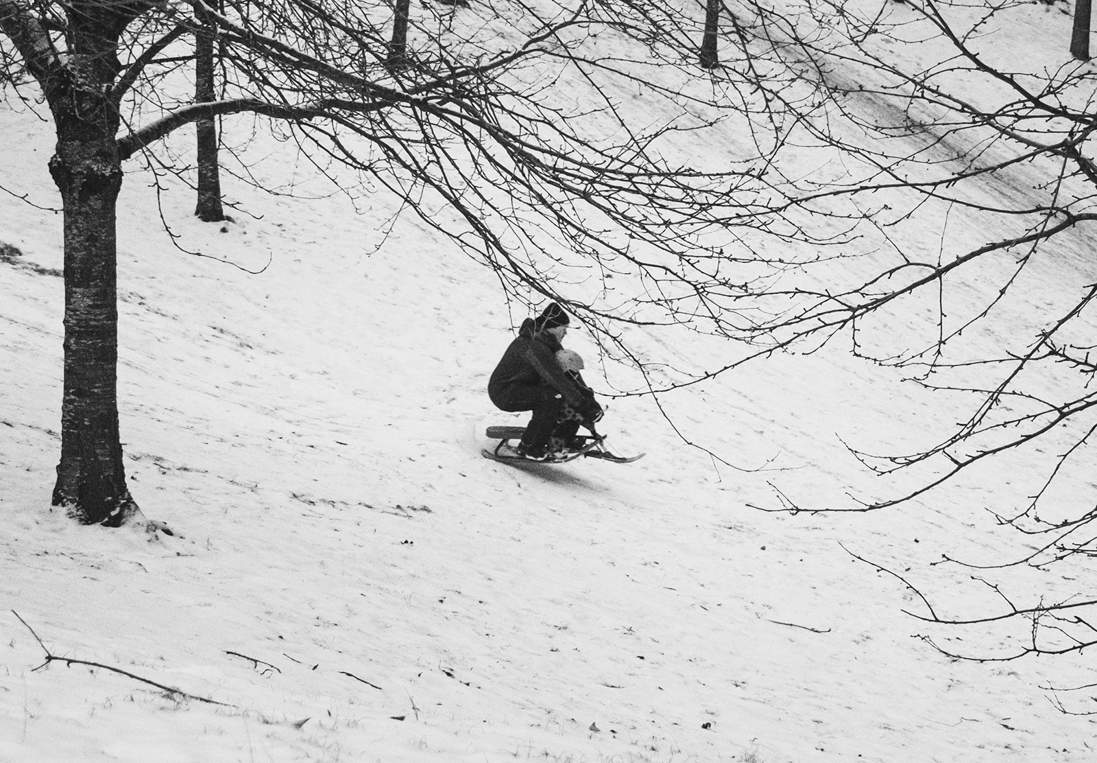 Man and child on sledge