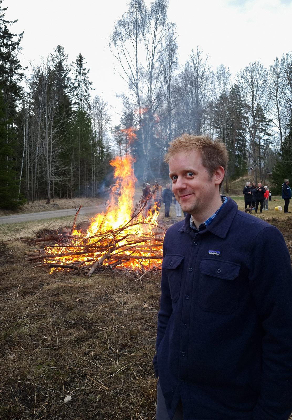 Man stood in front of bonfire