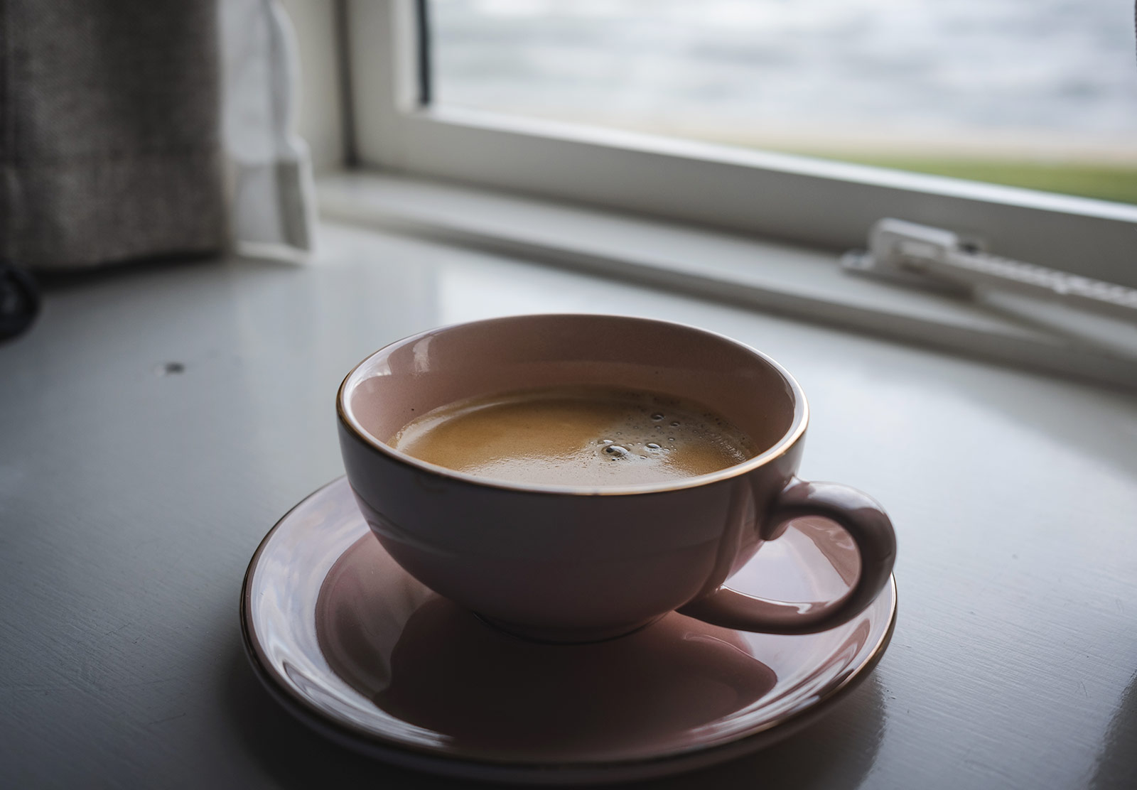 Coffee cup on windowsill