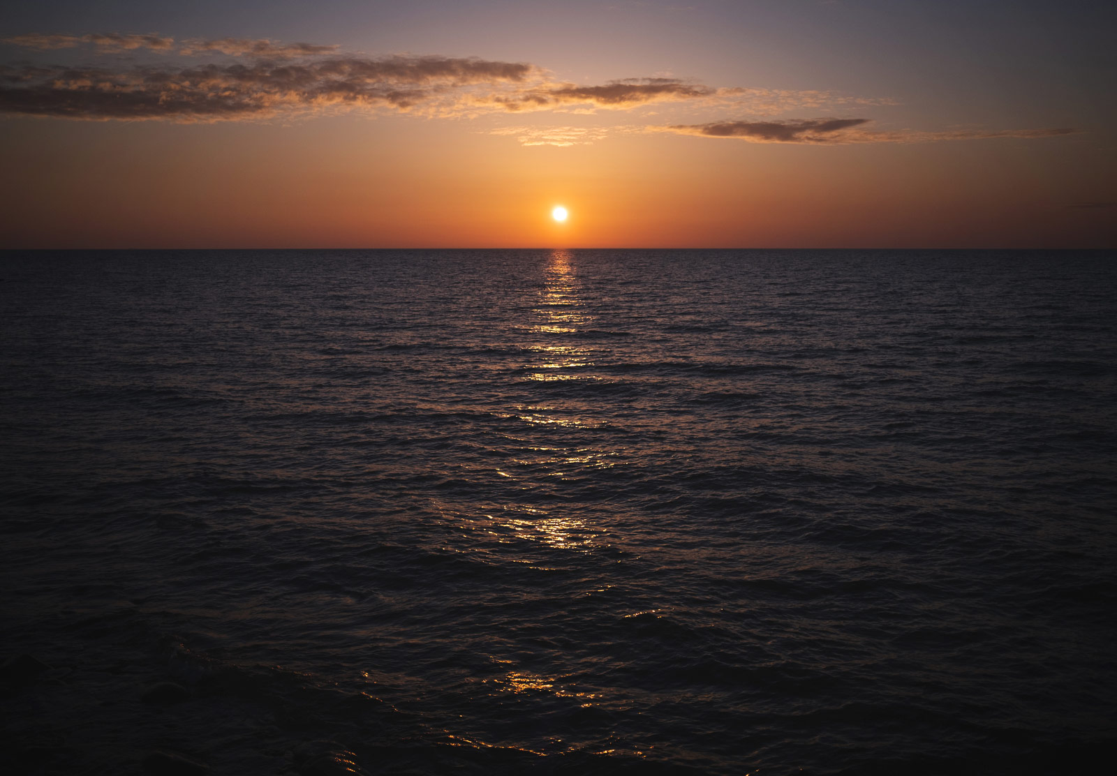 Sun setting above ocean