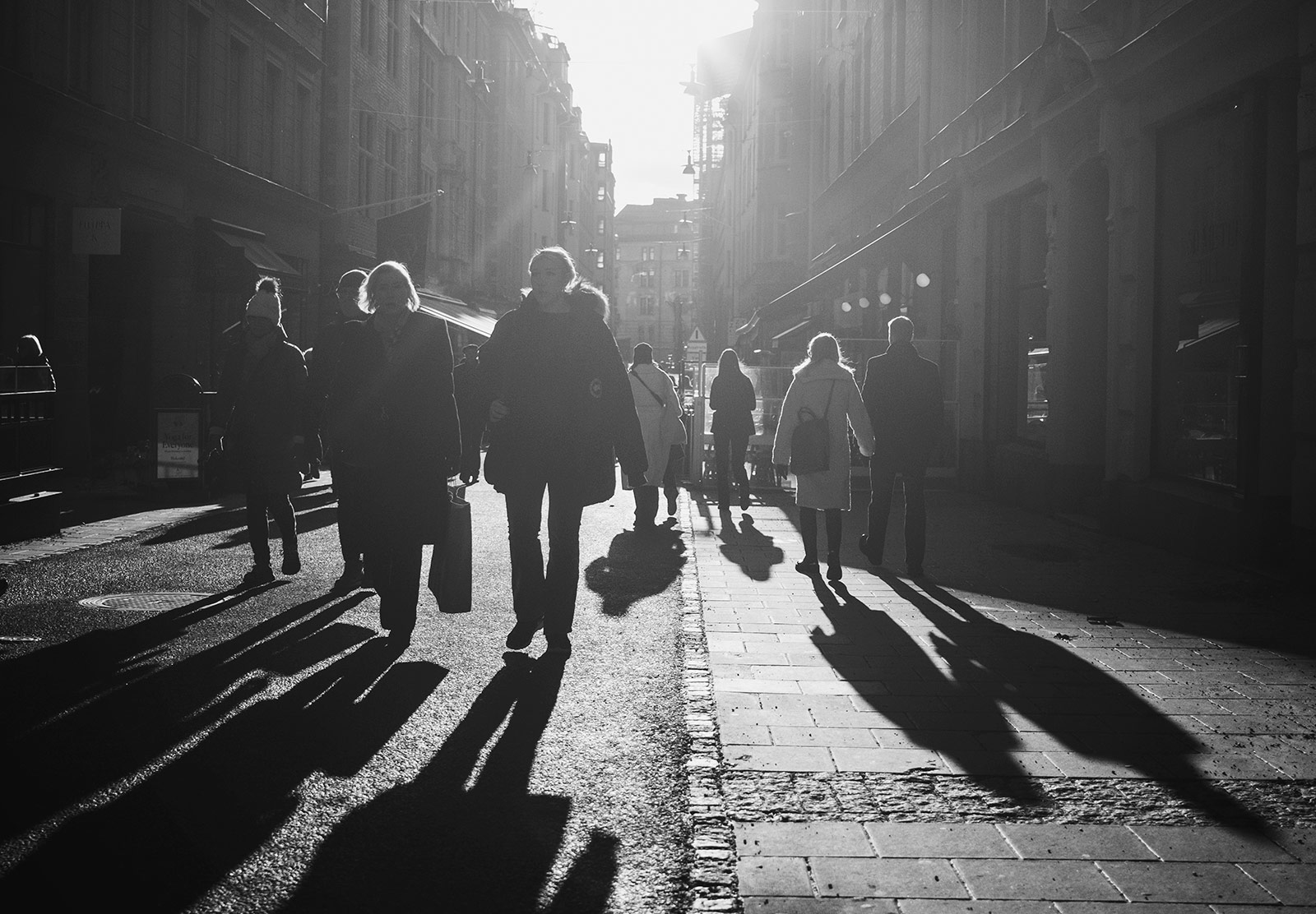 People and shadows in the street