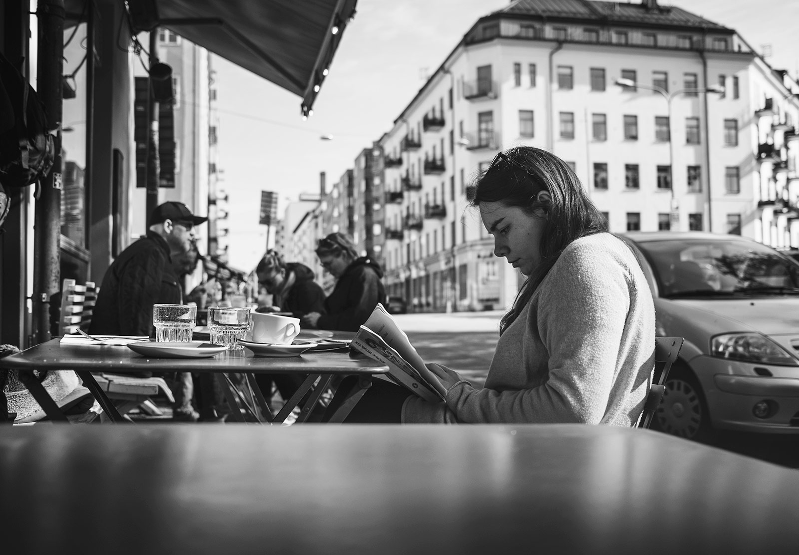 Woman reading book at café table